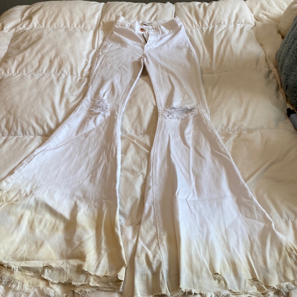 high waisted stretchy jeans, bell bottoms, slightly discolored at the bottom,